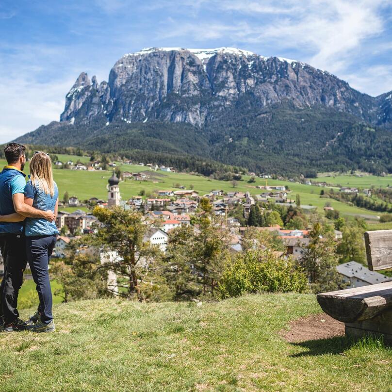 Ein Mann und eine Frau blicken auf Völs am Schlern