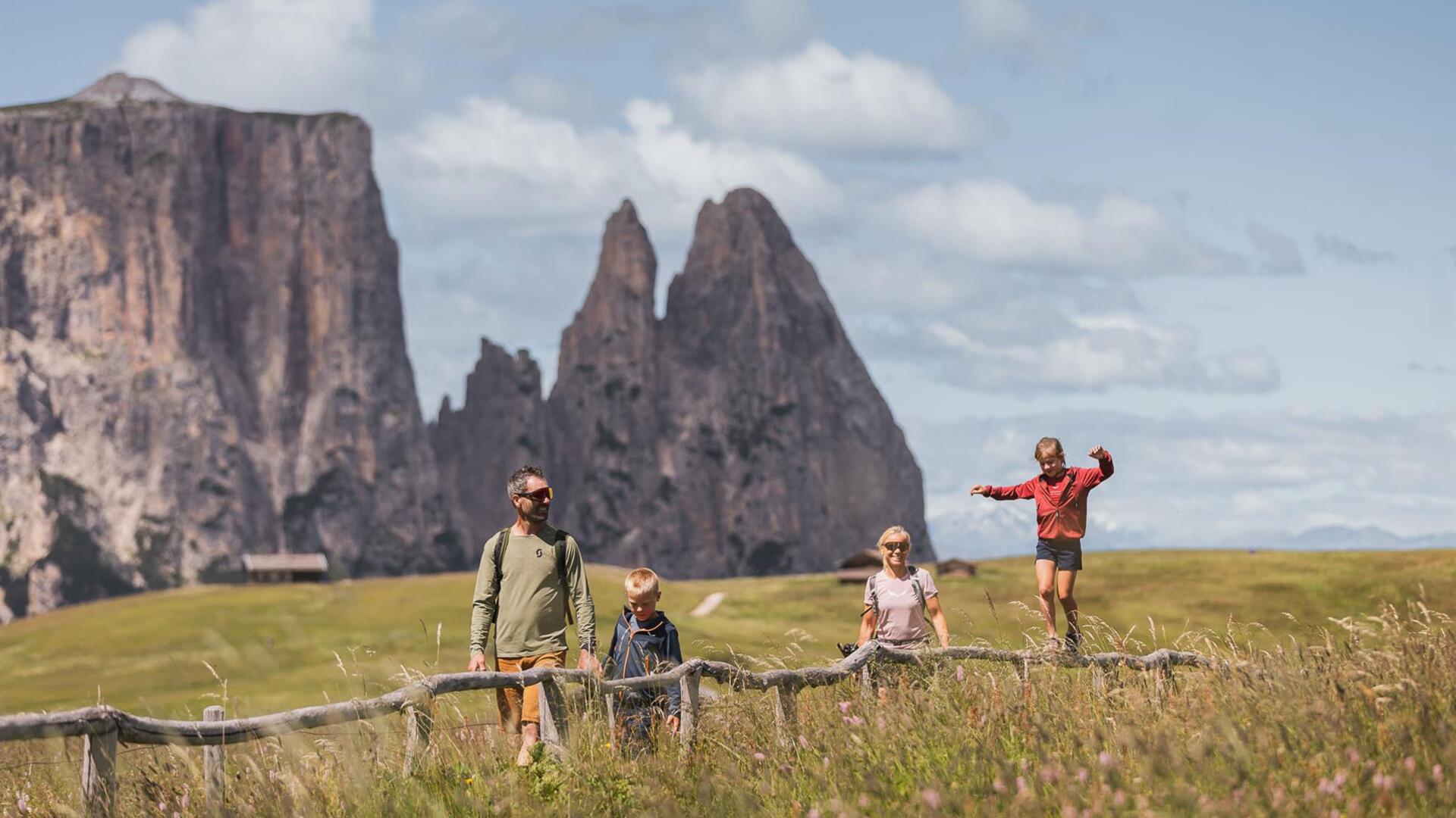 Eine Familie mit zwei Kindern beim Wandern auf der Seiser Alm