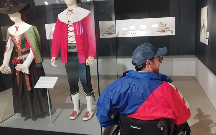 Ein Mann im Rollstuhl im Trachtenmuseum